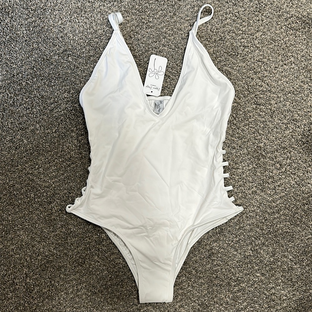 Dippin’ Daisy’s white swimsuit
